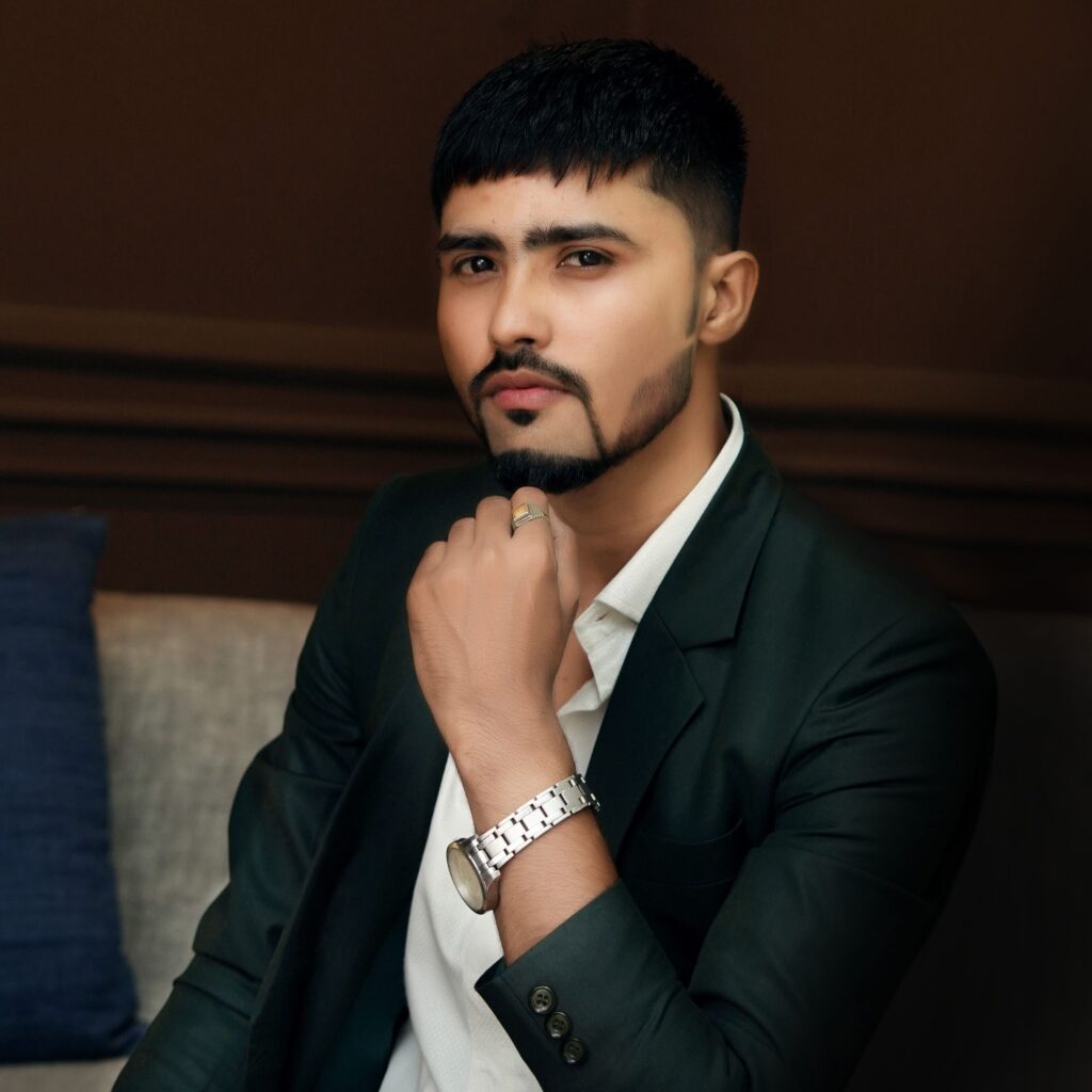 Elegant portrait of a bearded man posing confidently in a fashionable suit indoors.